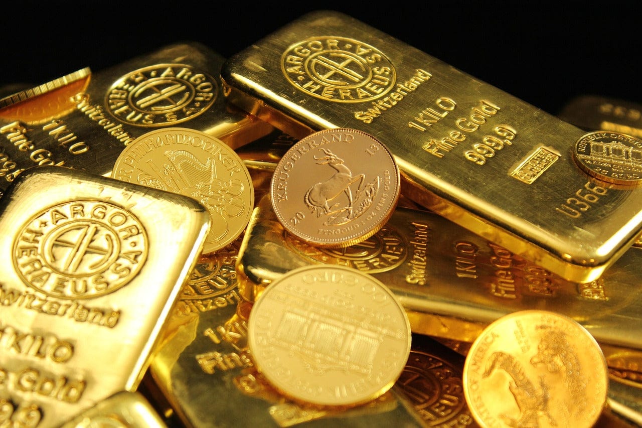 Image with a selection of gold bullion coins, bars.